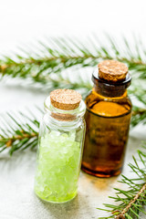 fir branches and spruce bath salt and aroma oil on white table b