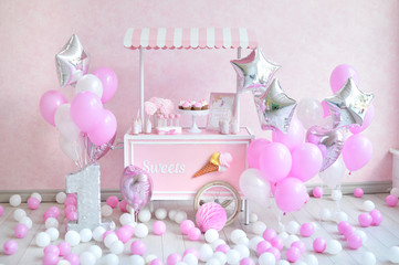 One year birthday decorations. Decorations for holiday party. a lot of balloons pink and white colors. Decorations for princes. 