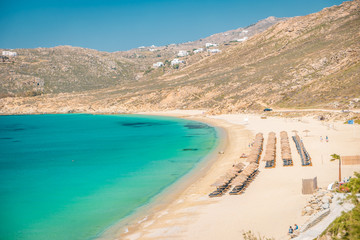 Beach with chars and umbrella of Mykonos Greece
