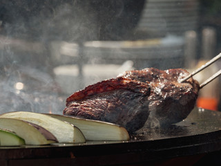 Assorted delicious grilled meat with vegetables over the coals on barbecue