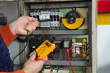 electrician fixing  electrical system with different tools