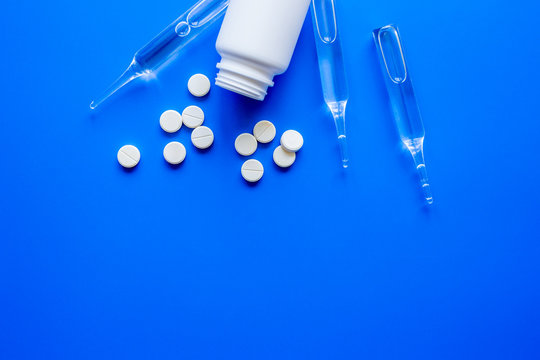 pills, vials in medical room on blue background top view mockup