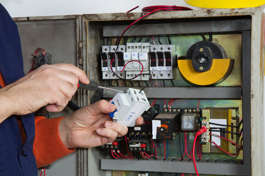 electrician fixing  electrical system with different tools