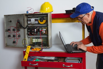 electrician fixing  electrical system with different tools