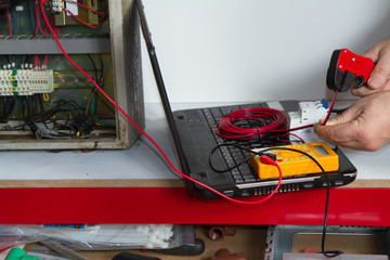 electrician fixing  electrical system with different tools