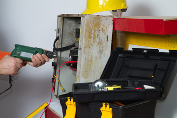 electrician fixing  electrical system with different tools