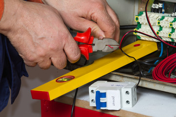 electrician fixing  electrical system with different tools