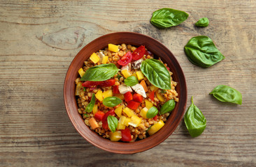 Bowl with tasty lentil dish on table
