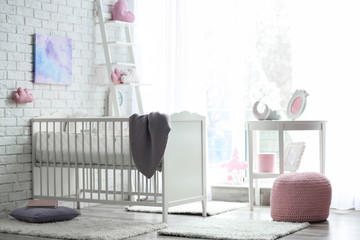 Beautiful interior of baby room with  crib