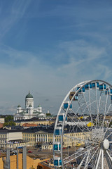Ferris wheel and Cathedral of the Diocese of Helsinki, finnish Evangelical Lutheran church, located...