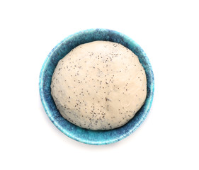 Raw dough with poppy seeds in bowl on white background, top view