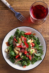 Strawberry, avocado, basil, mint, arugula salad with brie cheese and jamon or prosciutto. Healthy salad bowl. View from above, top studio shot