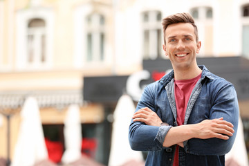 Portrait of attractive young man in stylish outfit outdoors