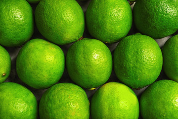 Fresh ripe green limes as background