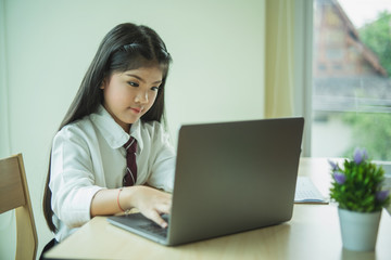 Young girl use of the laptop compute
