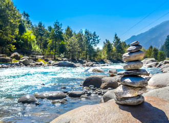 Balance and wellness retro spa concept, inspiration, zen-like and wellbeing tranquil composition. Close-up of white pebbles stack over near river side.