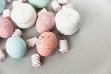 Painted eggs with marshmallows.Creative Easter composition.Pastel light colors.Top view.Copy space