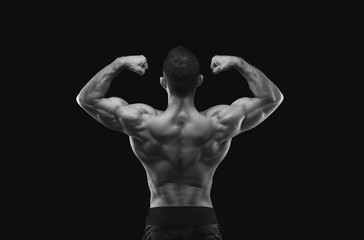 Obraz premium Unrecognizable man shows strong back muscles closeup