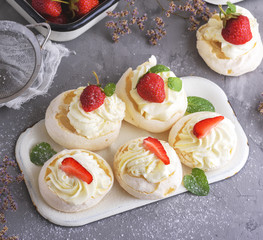 meringue cakes with cream and fresh strawberries