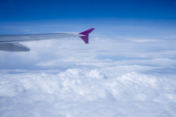 Fototapeta na wymiar Airplane view above the clouds