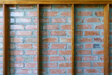 Grunge vintage brick wall with wooden frame.
