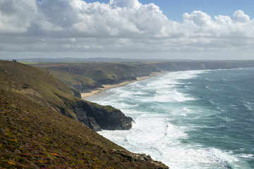 View along the St Agnes Heritage Coast towards Chapel Porth Beach on a sunny summer afternoon in Cornwall, UK