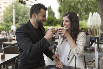 Couple in bar celebratibng anniversary and drinking beer and valentines