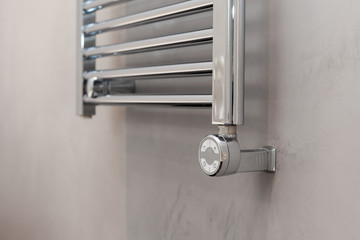 Thermostat for the towel warmer in the bathroom