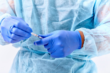 doctor using a syringe in a hospital during a surgical operation on white background