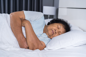 old woman sleeping on a bed