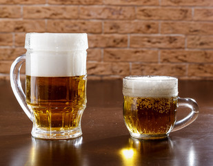 Two mugs of beer on the table.
