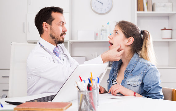 Doctor And Girl With Sore Throat