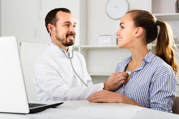 Fototapeta na wymiar Smiling woman client with man doctor