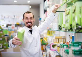 Smiling man pharmacist offering right drug