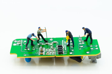 Miniature worker repairing mainboard, clear virus computer and repair, security and technology concept.