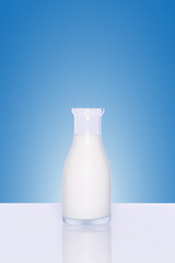 Bottle of milk on white background