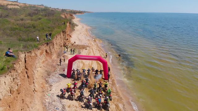 Aerial view of the final stage of the Enduro extreme races on the ocean coast among the rocks. Final of the competition in high resolution 4K.