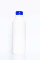 Bottle of milk on white background