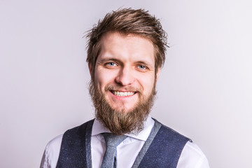 Portrait of a young hipster man in a studio. Copy space.