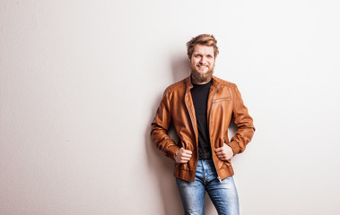 Portrait of a young hipster man in a studio. Copy space.