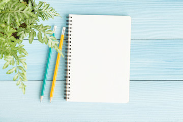 Blank notebook with and pencil on blue background,Flat lay photo of notebook for your message