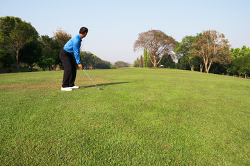 man playing golf.