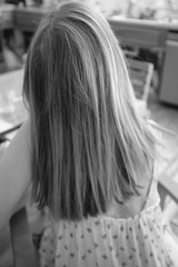 Womans hair view in causal kitchen setting B&W image film look