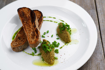 Gourmet Italian snack, restaurant menu ,food photo concept. Chef's olive tapenada and crunchy rye baguette in restaurant serving