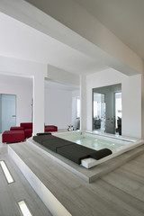 modern bathroom interior in the foreground the whirlpool bathtub the floor is made of wood