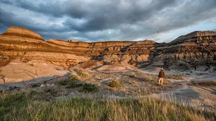 Man standing and taking in the rock formations of the Alberta badlands in Dinosaur Lake Provincial Park
