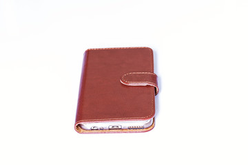Smartphone with leather case cover on white background