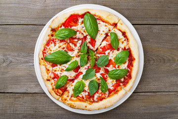 Italian food, Margherita pizza. Delicious pizza with mozzarella cheese, tomatoes and basil leaves....