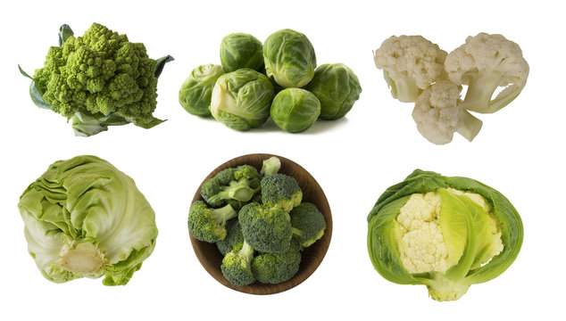 Different kinds of cabbage in a wooden bowl. Broccoli, Brussels sprouts, Roman cauliflower, green cabbage isolated on white background. Cabbage with copy space for text. 