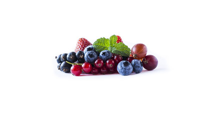 Fruits and berries isolated on white background. Ripe currants, blueberries, strawberries and gooseberries with a leaf of mint. Sweet and juicy fruits with copy space for text. 